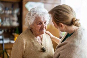 discovery-commons-cypress-point-assisted-living-senior-woman-smiling-at-nurse-300x200